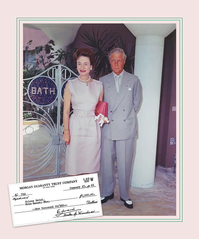 older couple standing arm in arm at hotel entrance